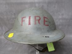 A 1939 DATED BRITISH TIN HELMET, inscribed 'FIRE' to front