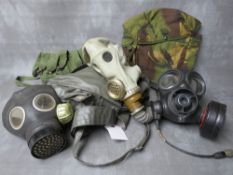 THREE ASSORTED GAS MASKS, a British example date 1954, a Russian type with gloves in pouch dated