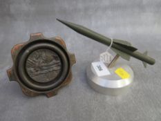 A 1915 LUSITANIA MEDAL, set into a dish, along with a bull ring and a rapier missile paperweight