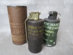 A US OFFENSIVE GRENADE, dated 1974, in original box, along with a training smoke screen grenade,