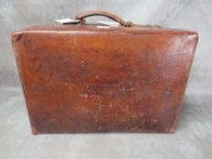 AN EARLY 20TH CENTURY POLISHED LEATHER SUITCASE, with brass furniture, with presentation plaque