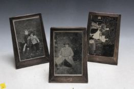 A MATCHING SET OF THREE HALLMARKED SILVER ART DECO STYLE PHOTO FRAMES BY ERNEST WILFRED SANDERS &