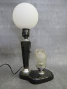 AN ART DECO BAKELITE TABLE LAMP WITH GLASS OWL CAR MASCOT, the glass owl car mascot illuminating