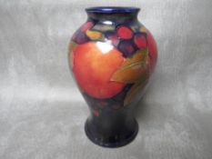 A MOORCROFT POMEGRANATE PATTERN BALUSTER VASE, impressed marks to base, H 16 cm