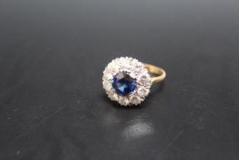 AN 18CT AND PLATINUM SAPPHIRE AND DIAMOND RING, the central sapphire being of an estimated 2.54