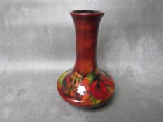 A WILLIAM MOORCROFT FLAMBE VASE, decorated with flowers, signed and impressed marks to the base, H