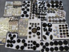 A TIN CONTAINING A COLLECTION OF ASSORTED CARDED VINTAGE BUTTONS, to include mainly jet and mother