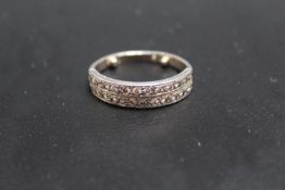 A TWIN ROW DIAMOND SET HALF ETERNITY RING, looks to have had a replacement shank with two resizing