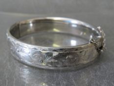 GEORG JENSEN - HALLMARKED SILVER HINGED BANGLE, with foliate decoration to one side, makers mark