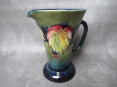 A MOORCROFT LEAF AND BERRY PATTERN EWER, impressed marks to the base, H 15.5 cm