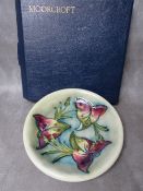 A WILLIAM MOORCROFT 'ARUM LILY' PATTERN CIRCULAR PLATE, impressed and signed marks Dia. 22 cm