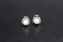 A PAIR OF HALLMARKED 9 CARAT GOLD PEARL AND DIAMOND EARRINGS, approx weight 2.2g, Dia 1 cm
