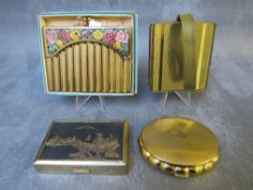 TWO VINTAGE MUSICAL COMPACTS, comprising a shaped Kigu example and a rectangular Clover example,