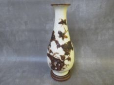 AN ORIENTAL STYLE PORCELAIN BALUSTER VASE, with floral applied detail, raised on a hardwood