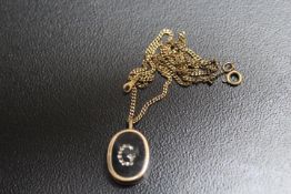A HALLMARKED 9 CARAT GOLD PENDANT, with what appears to be diamonds set in a jewelled 'case'