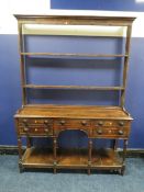 A 19TH CENTURY OAK DRESSER, with an arrangement of five drawers over an arched apron, raised on