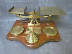 A VINTAGE SET OF POST OFFICE BRASS SCALES, on a wooden base, together with a set of brass weights, L