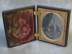 A 19TH CENTURY AMERICAN AMBROTYPE OF A SEATED LADY, in decorative case, portrait size 9 x 6.5 cm,
