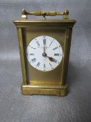 A SMALL 19TH CENTURY FRENCH REPEATER BRASS CARRIAGE CLOCK, with swing handle, H 14.5 cm