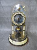 A 400 DAY KAISER UNIVERSE CLOCK WITH GLASS DOME, having a world globe rotating pendulum and upper