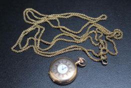A HALLMARKED 9 CARAT GOLD HALF HUNTER FOB WATCH, on a long muff style gold plated chain with