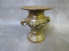 AN ORIENTAL BRONZE CAMPANA SHAPED VASE, decorated with storks in relief, twin-handled, character