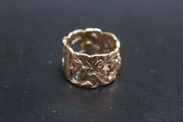 A HALLMARKED 9 CARAT GOLD PIERCED BAND, with floral design, approx weight 6.7g, ring size P 1/2