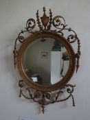 A 19TH CENTURY GILT CIRCULAR MIRROR, having an urn surmount with swag and rococo detail, H 95 cm,