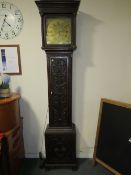 THOMAS WOODRUFF OF SALOP - A BRASS FACED CARVED OAK LONGCASE CLOCK, the face with date aperture