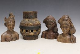 THREE INDONESIAN TRIBAL ART CARVED TEAL WOOD BUSTS, and a large heavy Indian cartwheel hub