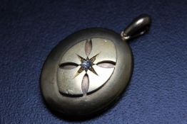 AN UNMARKED YELLOW METAL DIAMOND SET LOCKET, approx weight 22.7g, H 6 cm