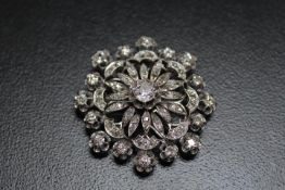 A DIAMOND ENCRUSTED PENDANT BROOCH, set with a central diamond of an estimated 1.07 carats, which is