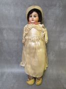 A 19TH CENTURY PORCELAIN BODIED DOLL, with horseshoe mark to nape of neck