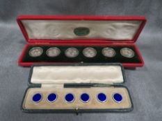 A CASED SET OF SIX HALLMARKED SILVER AND ENAMEL BUTTONS - CHESTER 1912, together with a cased set of