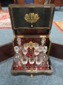 A 19TH CENTURY EBONISED AND BRASS INLAID DOMED DRINKS CABINET, the hinged lid opening to reveal