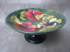 A WILLIAM MOORCROFT HIBISCUS PATTERN TAZZA, with impressed and printed marks to base with original