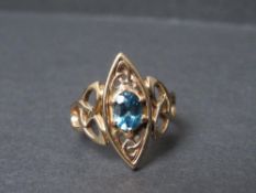 A VINTAGE CLOGAU GOLD LADIES 9CT GOLD LADIES DRESS RING, of Celtic design, set with blue stone, ring