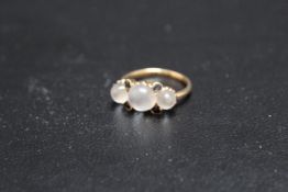 A VINTAGE THREE STONE MOONSTONE AND SAPPHIRE RING, set in unmarked yellow metal, approx weight 3.6g,