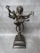 AN EASTERN BRONZE FIGURE OF DANCING EIGHT ARMED SHIVA, standing one legged atop an elephant head