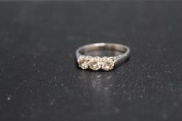 A HALLMARKED 18 CARAT GOLD DIAMOND TRILOGY RING, each diamond being of an estimated quarter carat,