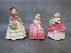 A ROYAL DOULTON 'CISSIE' FIGURINE HN1809, 'Rose' figure HN1368 and an un-named figure (3) A/F