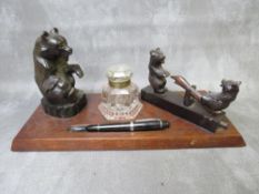 AN EARLY 20TH CENTURY BLACK FOREST STYLE INKSTAND, modelled with a seated bear, central heavy