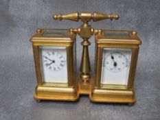 A BRASS CLOCK / BAROMETER DESK COMPENDIUM, within a corniche brass case, surmounted by a carrying