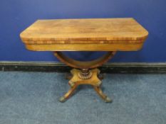 A REGENCY ROSEWOOD FOLD-OVER CARD TABLE, opening to a green baize surface, raised on a demi-lune