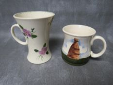 A MOORCROFT 'KILN' MUG, dated 1986, H 9 cm, together with another taller floral mug (2)