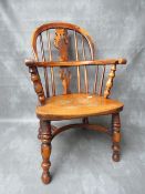 A CHILDS TRADITIONAL ELM WINDSOR ARMCHAIR