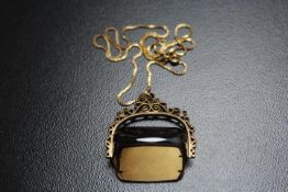 A LARGE THREE SIDED SMOKEY QUARTZ IN REVOLVING HALLMARKED 9 CARAT GOLD MOUNT, on an unmarked