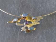 PAULA BOLTON - AN UNUSUAL GEMSET PENDANT NECKLACE, the freeform pendant set with a selection of