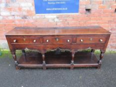 A 19TH CENTURY OAK DRESSER - POSSIBLY SHROPSHIRE, having three frieze drawers above a shaped
