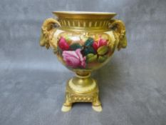 A ROYAL WORCESTER BLUSH IVORY PEDESTAL VASE, decorated with roses , having rams head masks to each